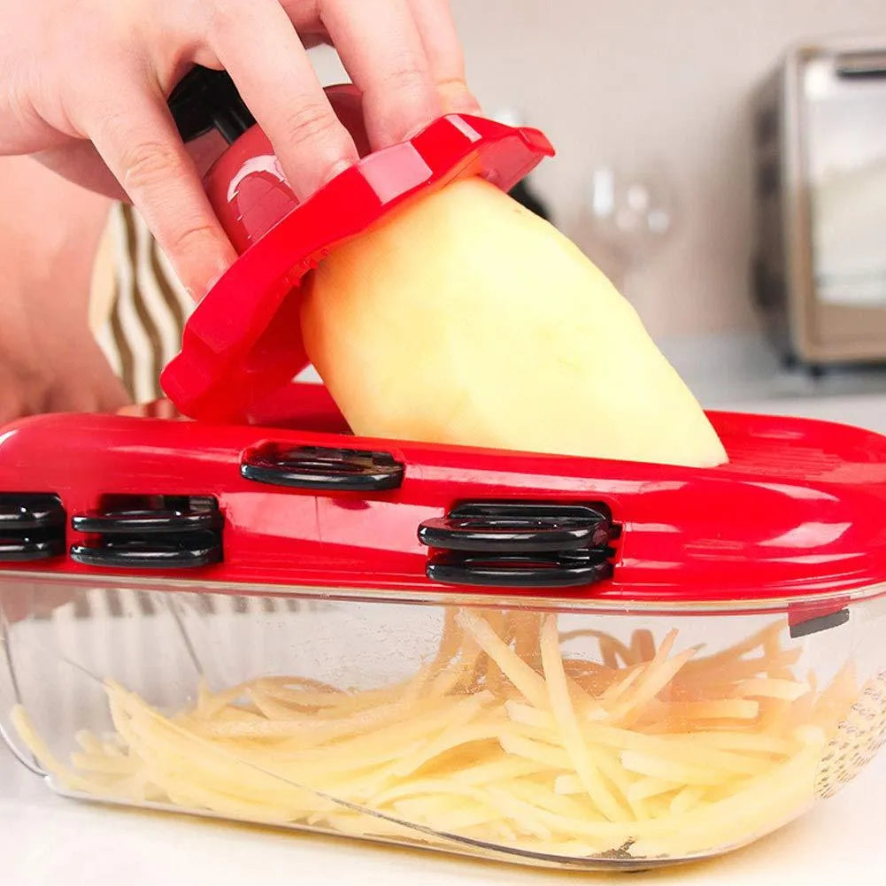 Red multi-function vegetable cutter with seven stainless steel blades, a plastic body, and a hand guard.
