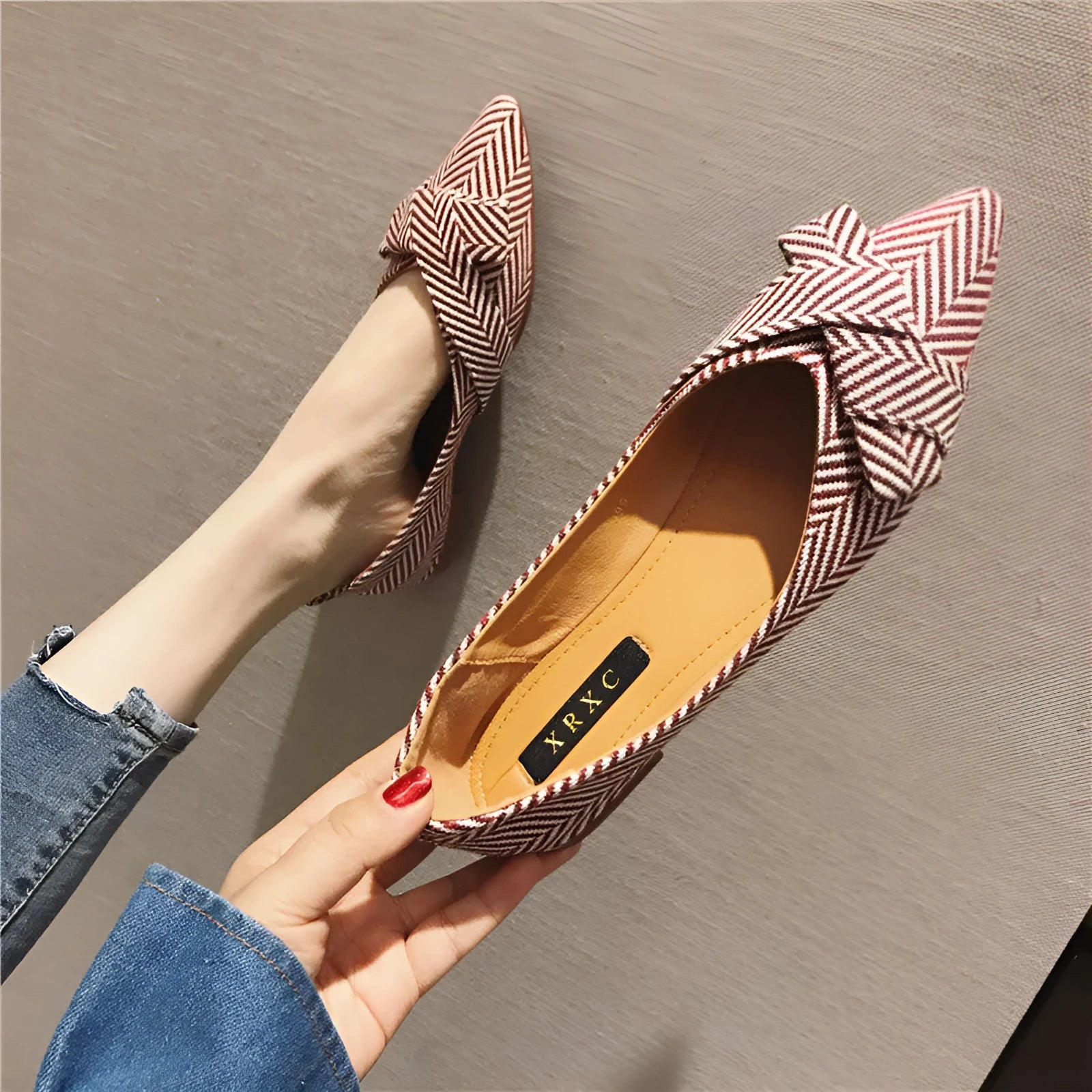 Women's red pointed toe flat shoes with a shallow V-neck opening and low flat heel.