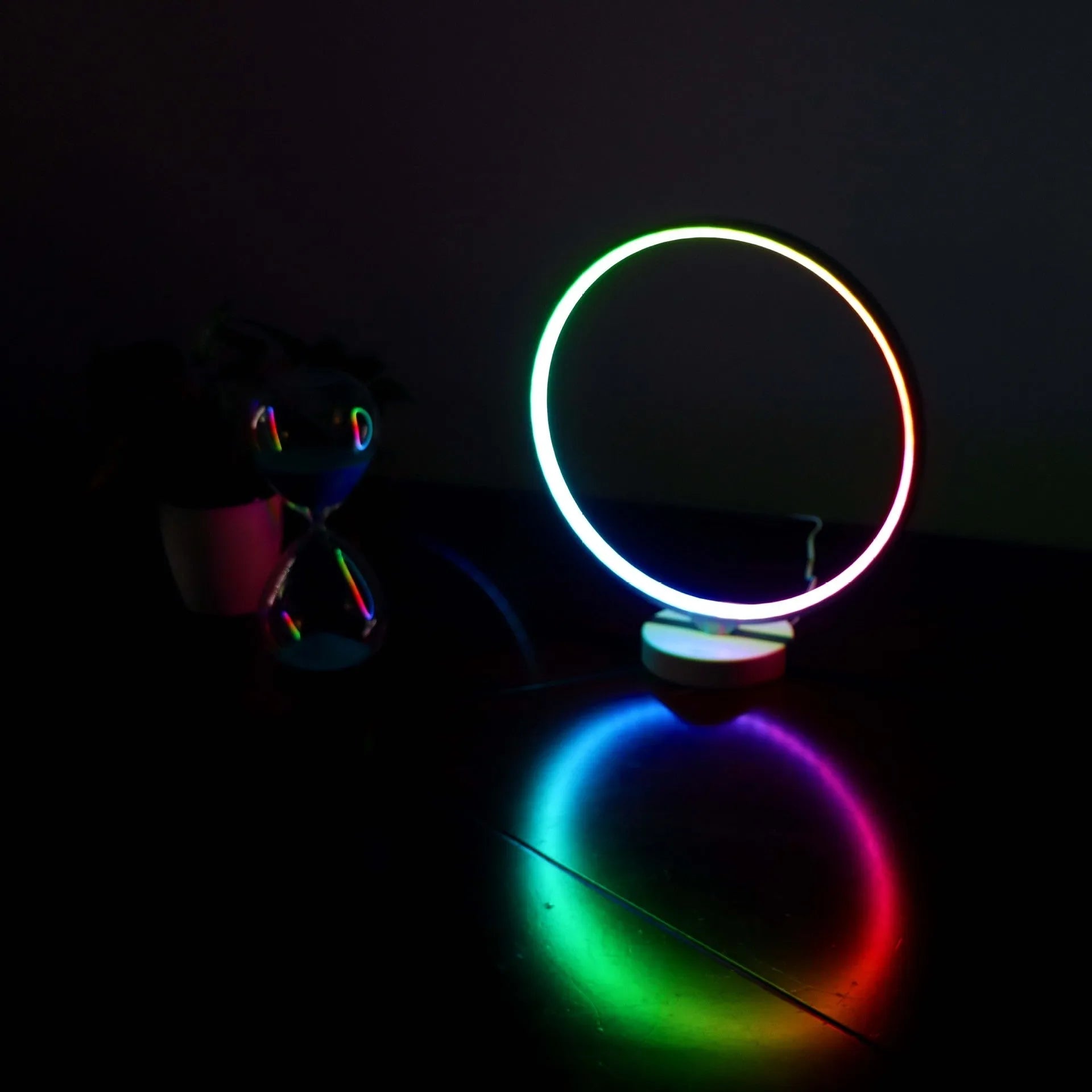 White Full Moon shaped mood lamp with remote control on a wooden desk.