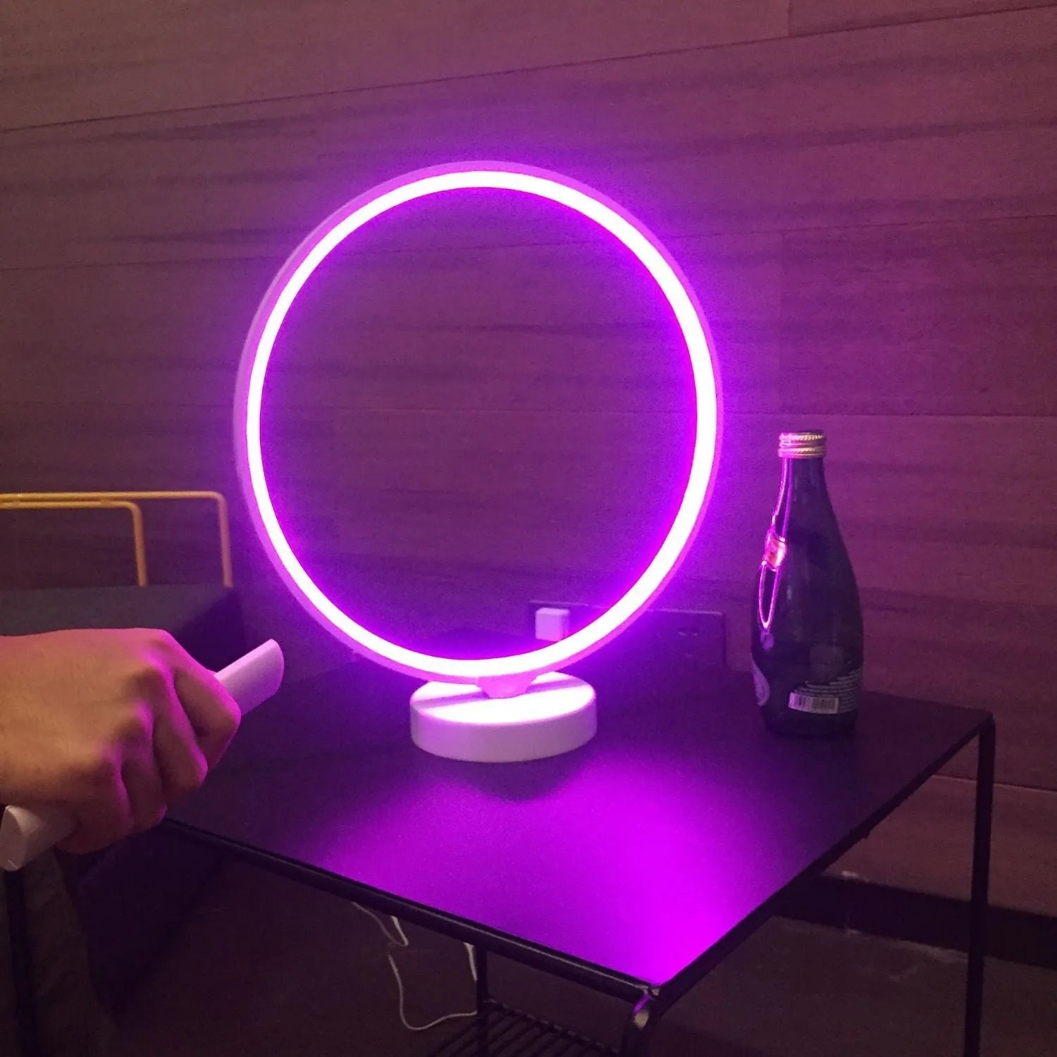 White Full Moon shaped mood lamp with remote control on a wooden desk.