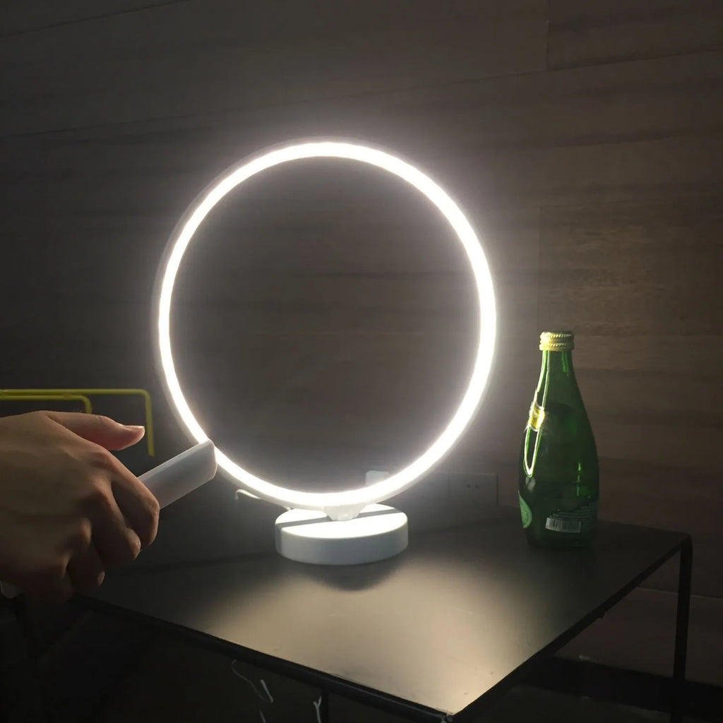 White Full Moon shaped mood lamp with remote control on a wooden desk.