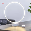White Full Moon shaped mood lamp with remote control on a wooden desk.