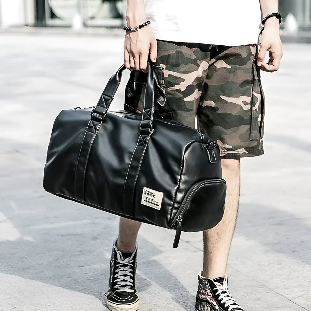 Black waterproof PU leather sports training bag with multiple organisational pockets