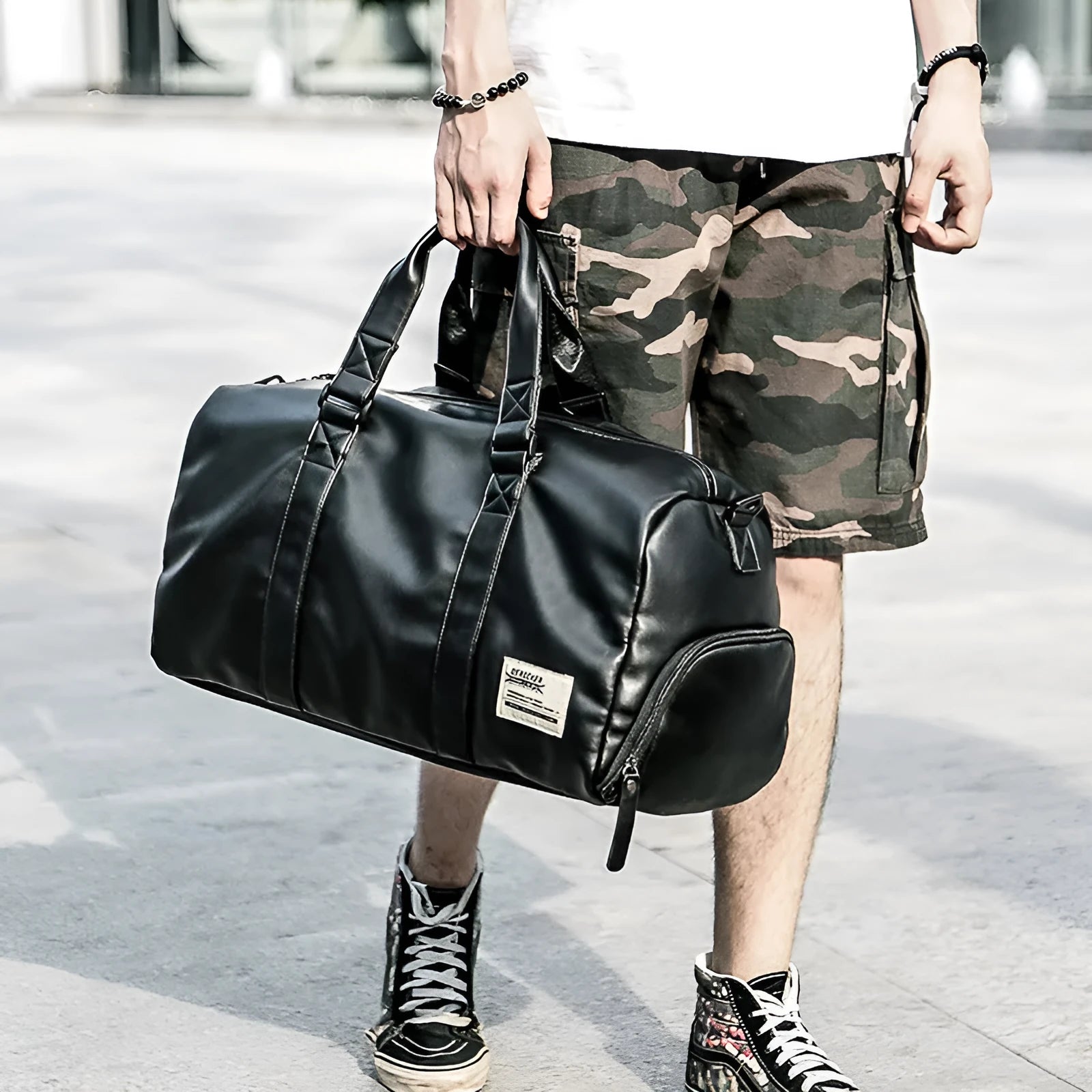 Black waterproof PU leather sports training bag with multiple organisational pockets