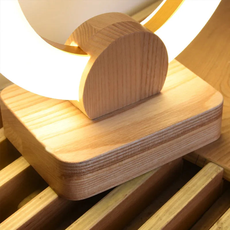 Wooden art circular Nordic style chandelier with a round acrylic shade, shown in a living room setting.