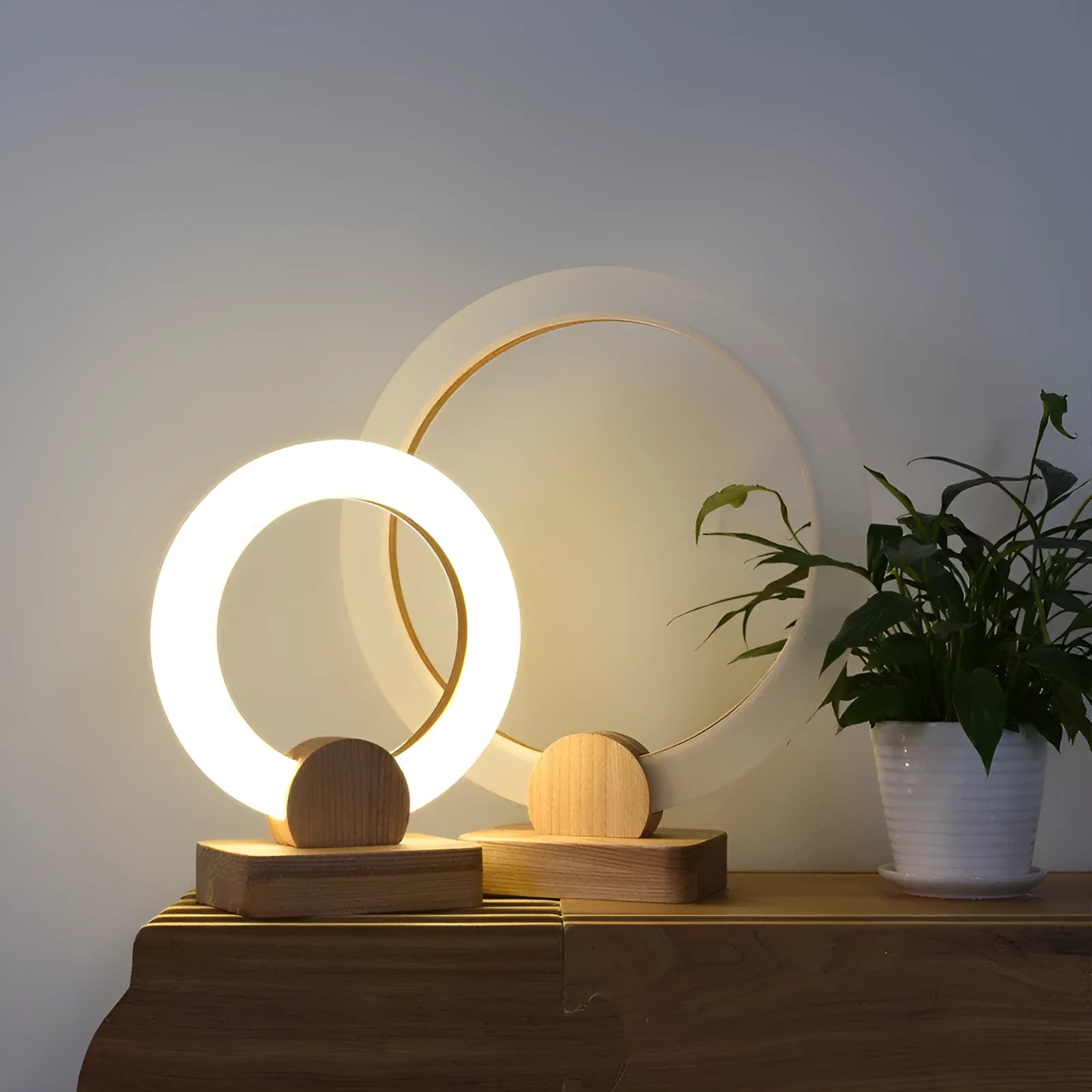 Wooden art circular Nordic style chandelier with a round acrylic shade, shown in a living room setting.