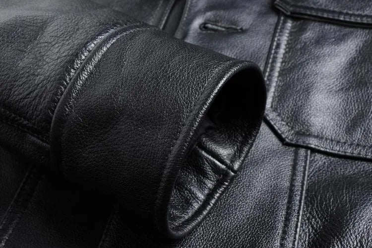 Men's short slim black leather jacket in first layer cowhide with lapel collar and zipper placket, sizes M and L.