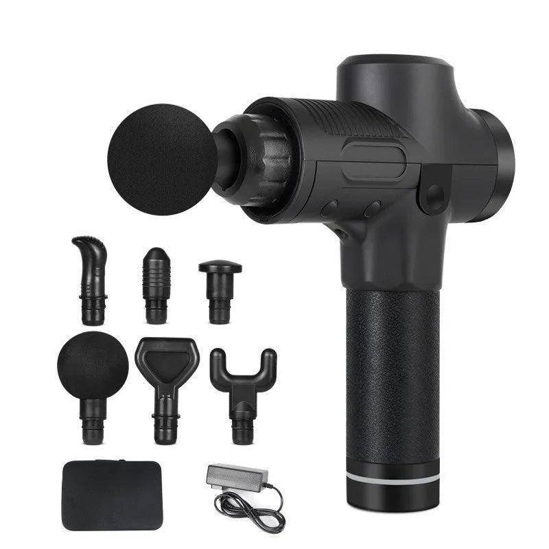 Black electric percussion massage gun with 7 different coloured attachment heads on a table.