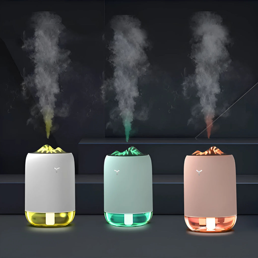 White columnar Magic Flame ultrasonic humidifier with USB cable on a wooden desk