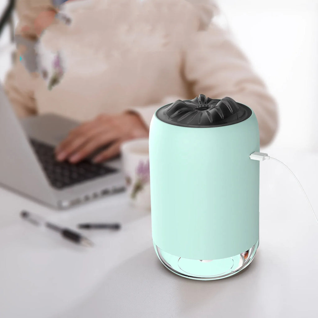 White columnar Magic Flame ultrasonic humidifier with USB cable on a wooden desk