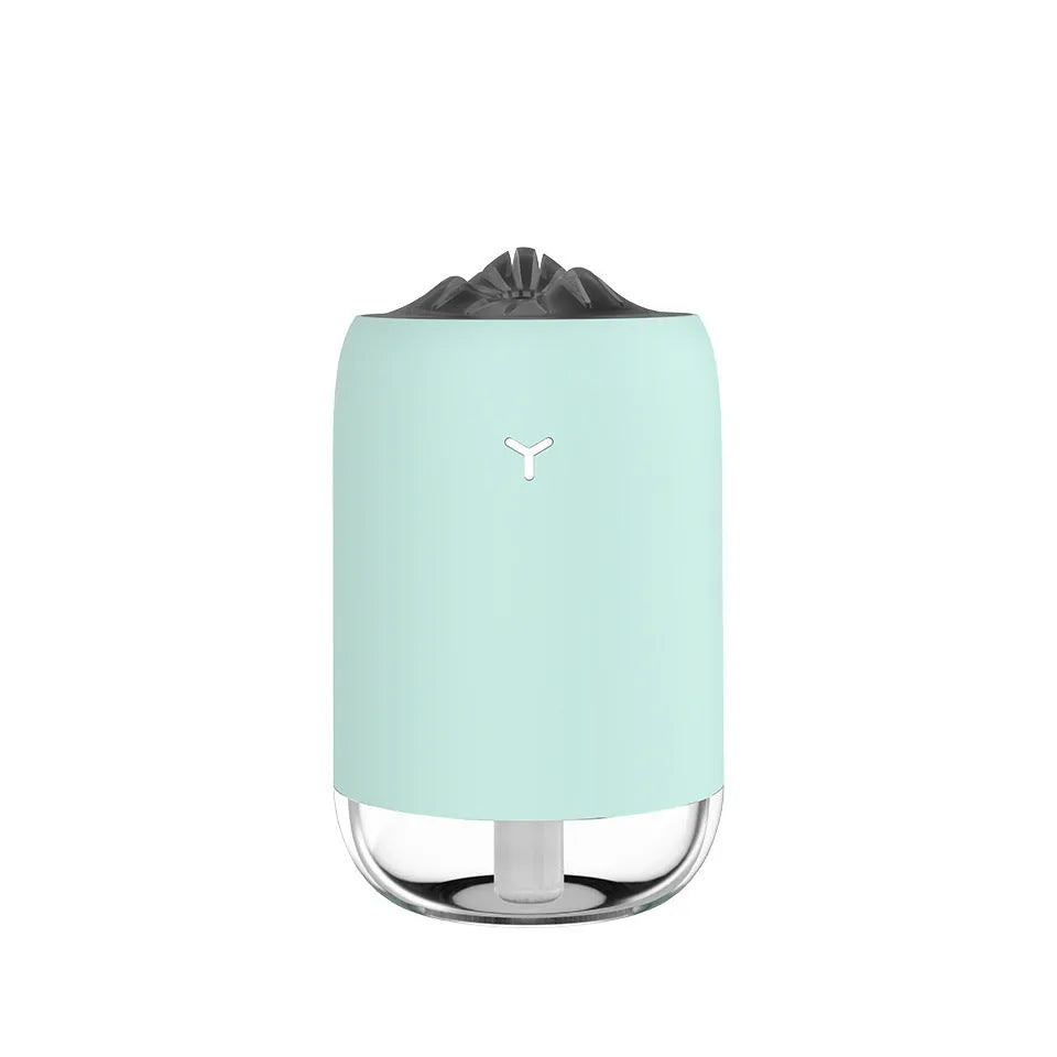 White columnar Magic Flame ultrasonic humidifier with USB cable on a wooden desk
