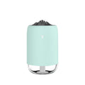 White columnar Magic Flame ultrasonic humidifier with USB cable on a wooden desk