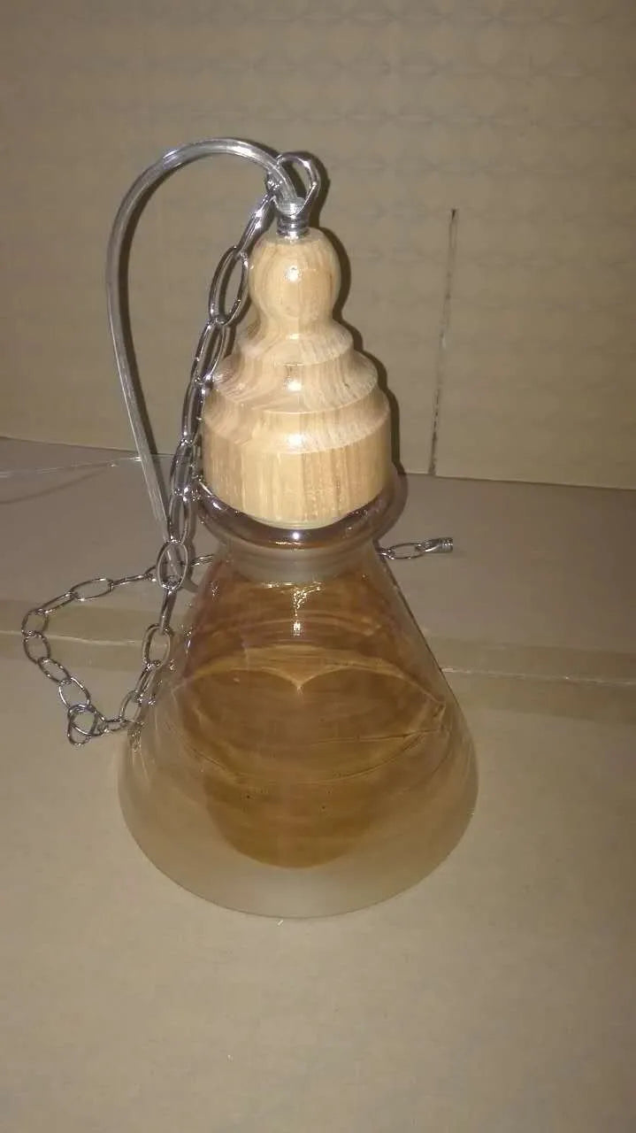 Glass wood grain single head pendant light with adjustable cord on white background