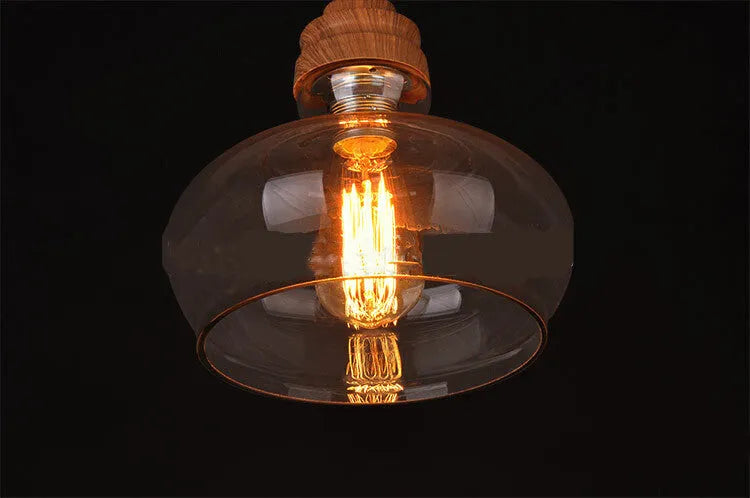 Glass wood grain single head pendant light with adjustable cord on white background