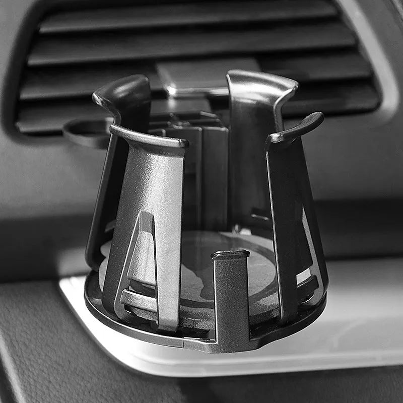 Black universal car air outlet beverage holder made from ABS plastic clipped onto a vehicle vent