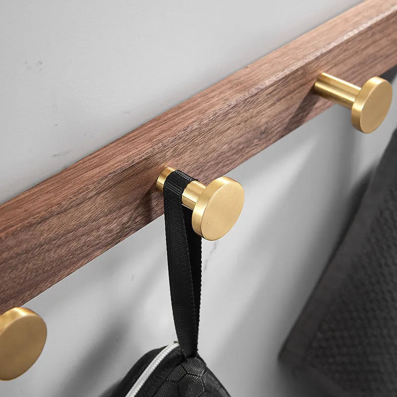 Black walnut bathroom clothes hooks with aluminium frame and brass finish in perforated row design