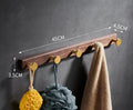 Black walnut bathroom clothes hooks with aluminium frame and brass finish in perforated row design