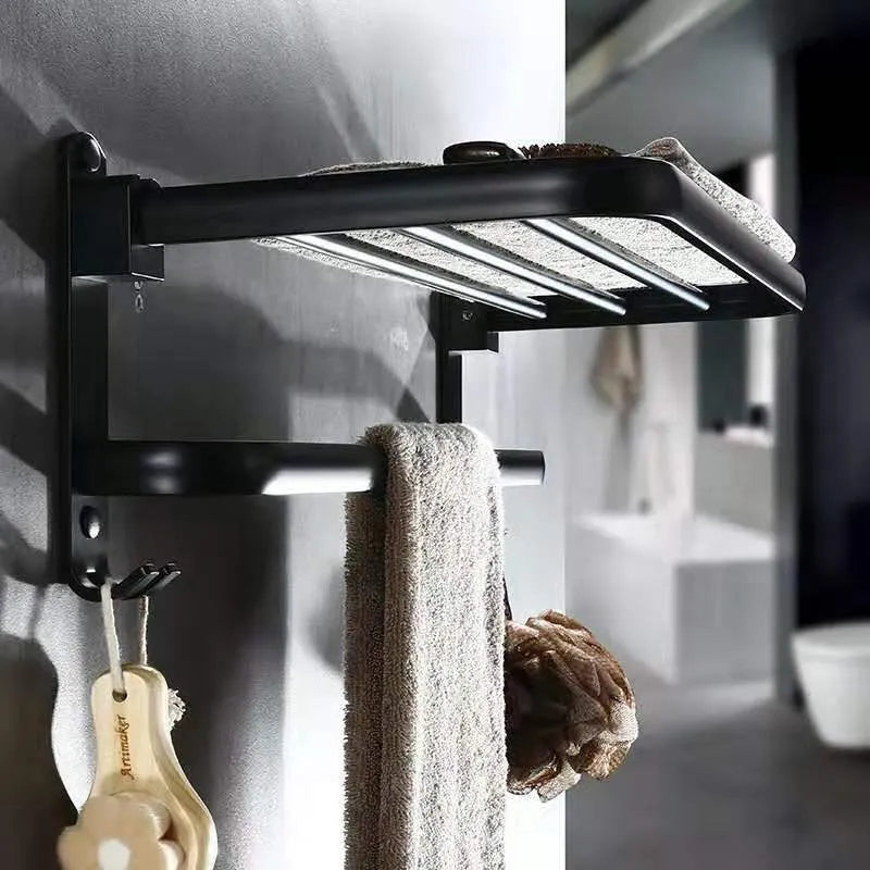 Silver anodised aluminium two-tier folding towel rack mounted on a bathroom wall.