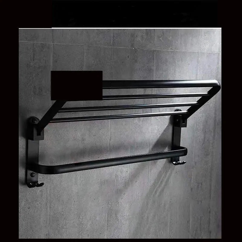 Silver anodised aluminium two-tier folding towel rack mounted on a bathroom wall.