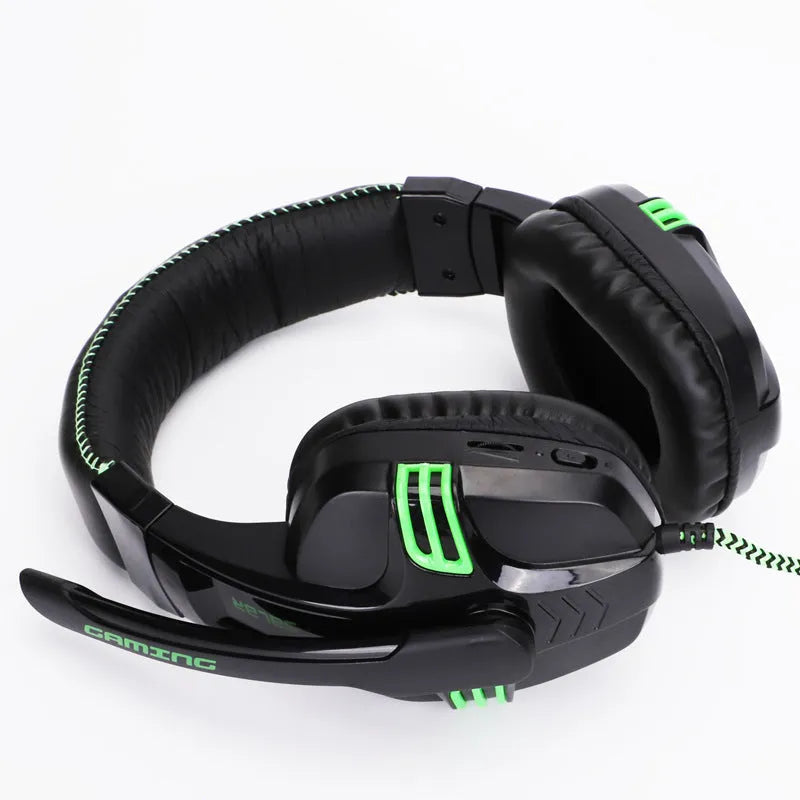 Black wired gaming headset with microphone placed on a desk, 3.5mm plug visible