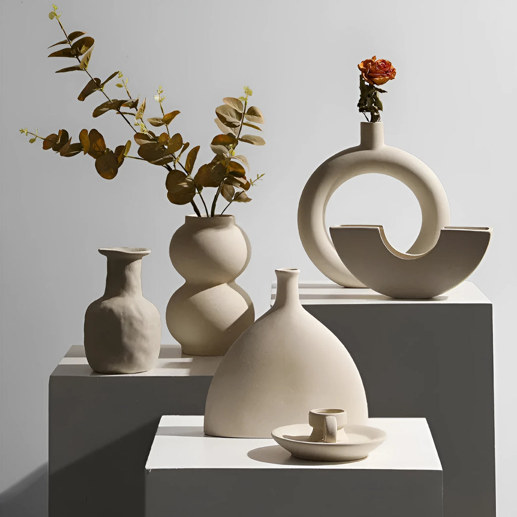 Modern minimalist painted ceramic vase with geometric shape, handmade pottery ornament on shelf