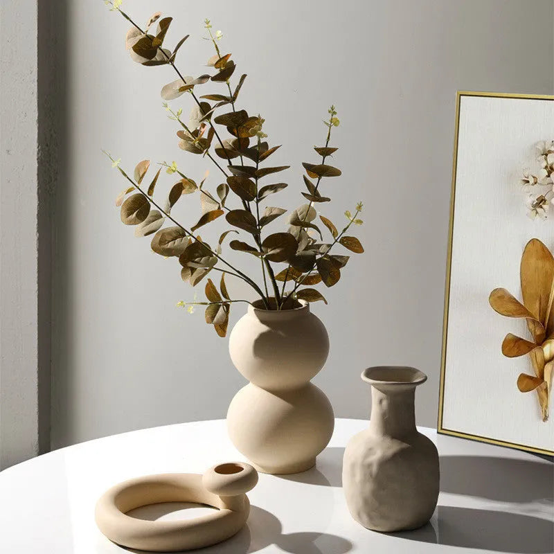 Modern minimalist painted ceramic vase with geometric shape, handmade pottery ornament on shelf
