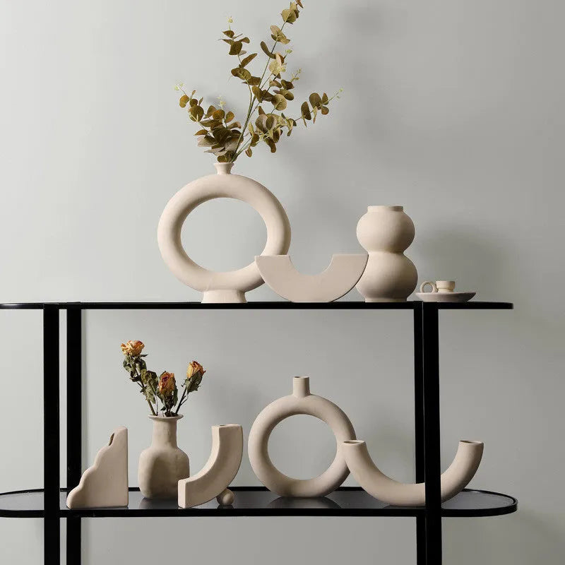 Modern minimalist painted ceramic vase with geometric shape, handmade pottery ornament on shelf