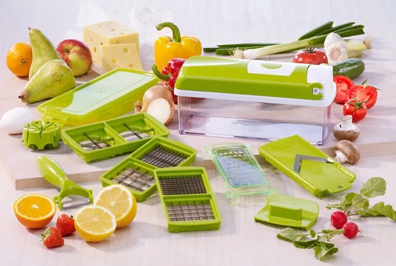 Green manual vegetable chopper with stainless steel blades on a kitchen counter