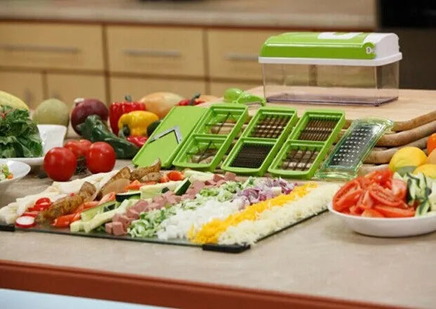 Green manual vegetable chopper with stainless steel blades on a kitchen counter