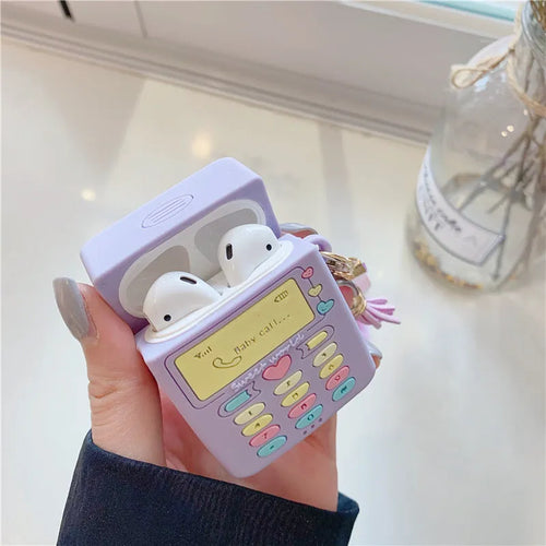 Purple silicone clamshell case for Apple AirPods with fur ball pendant attached