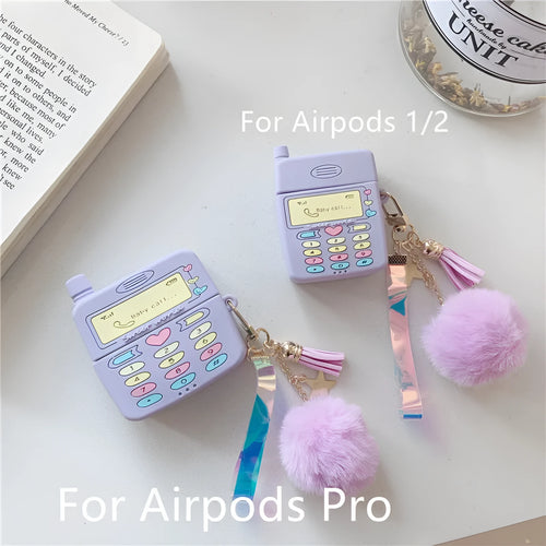 Purple silicone clamshell case for Apple AirPods with fur ball pendant attached
