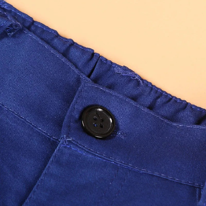 Blue boys' suit set with turtleneck, waistcoat, tie, and trousers on a hanger.