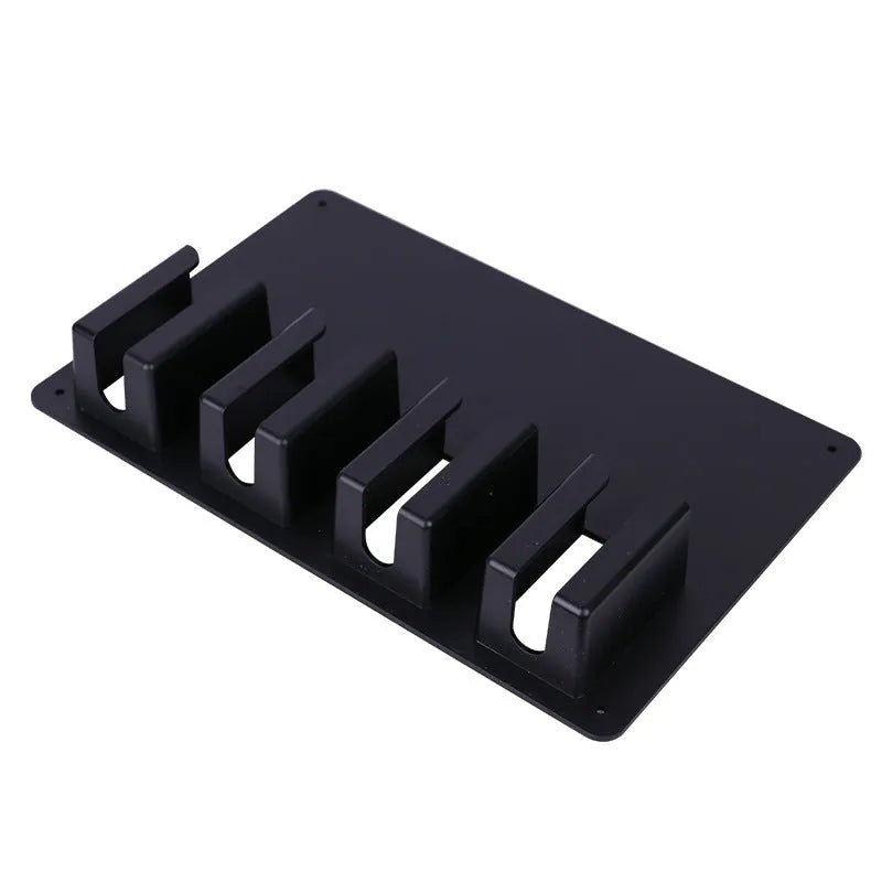 Black plastic wall-mounted frame holding four hair clippers and a hair dryer for salon storage.