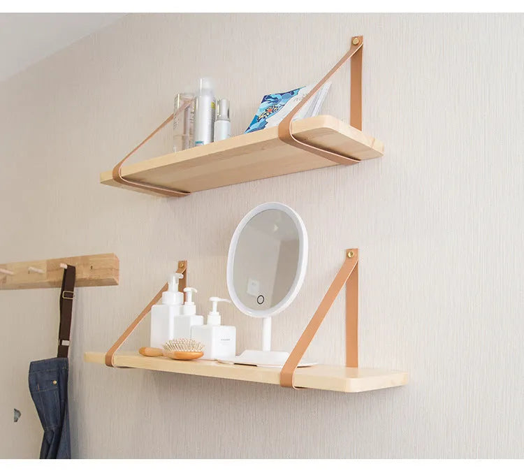 Pine wood wall-mounted storage shelf, 50cm wide by 16cm high, holding books and cosmetic items.