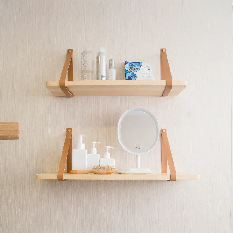 Pine wood wall-mounted storage shelf, 50cm wide by 16cm high, holding books and cosmetic items.