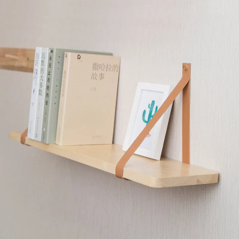 Pine wood wall-mounted storage shelf, 50cm wide by 16cm high, holding books and cosmetic items.