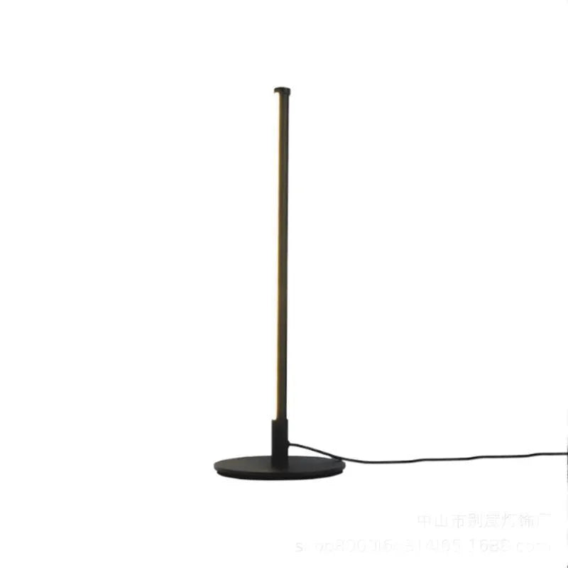 Nordic minimalist black or gold LED table lamp with RGB colour touch remote control on a bedside table.