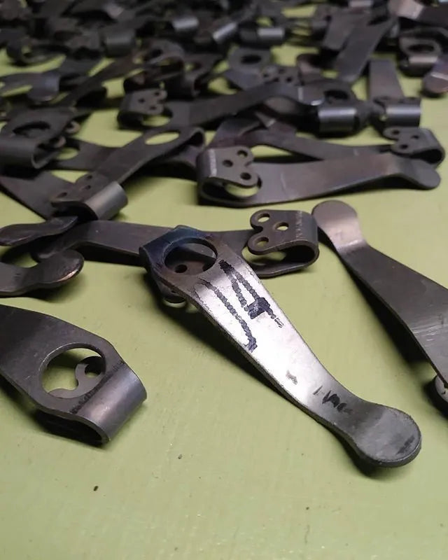 Titanium alloy knife holder with black stone wash finish and back clip for belt or waistband carry.