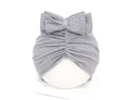 Soft acrylic knitted bonnet for a baby girl, shown in a solid colour, suitable for 0-28 month olds.