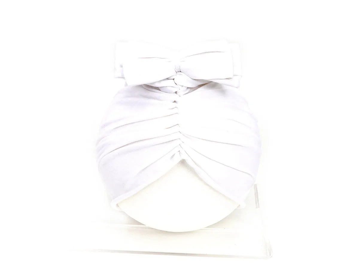 Soft acrylic knitted bonnet for a baby girl, shown in a solid colour, suitable for 0-28 month olds.