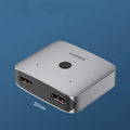Grey HDMI switcher with two input ports and one output port for sharing displays between devices