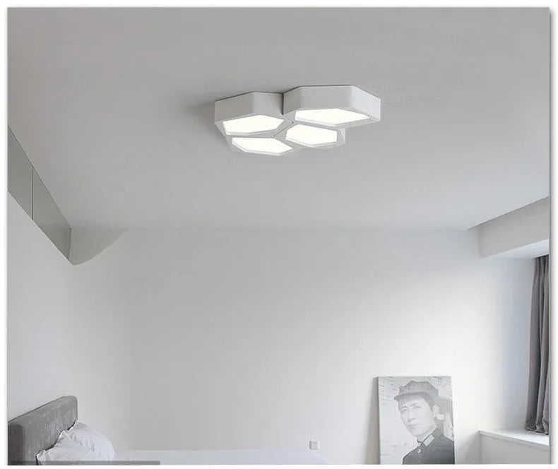 Black and white geometric shaped iron LED ceiling light on a ceiling, showing its special shape and modern design.