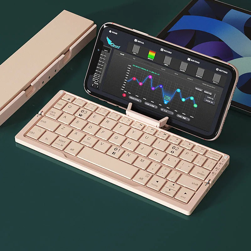 Silver white aluminium folding Bluetooth keyboard open with phone in stand showing 60-key layout