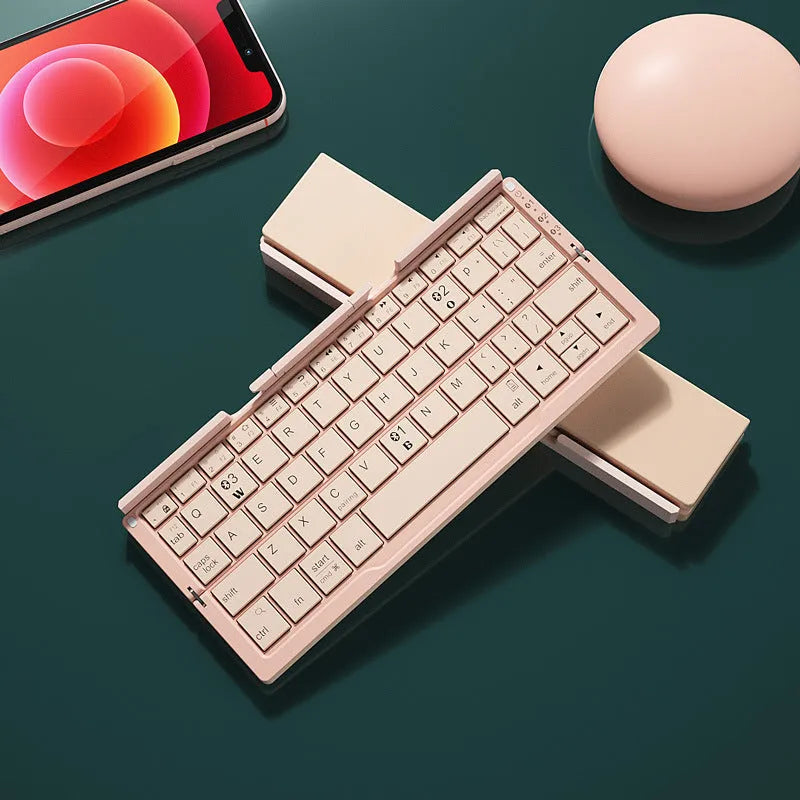 Silver white aluminium folding Bluetooth keyboard open with phone in stand showing 60-key layout