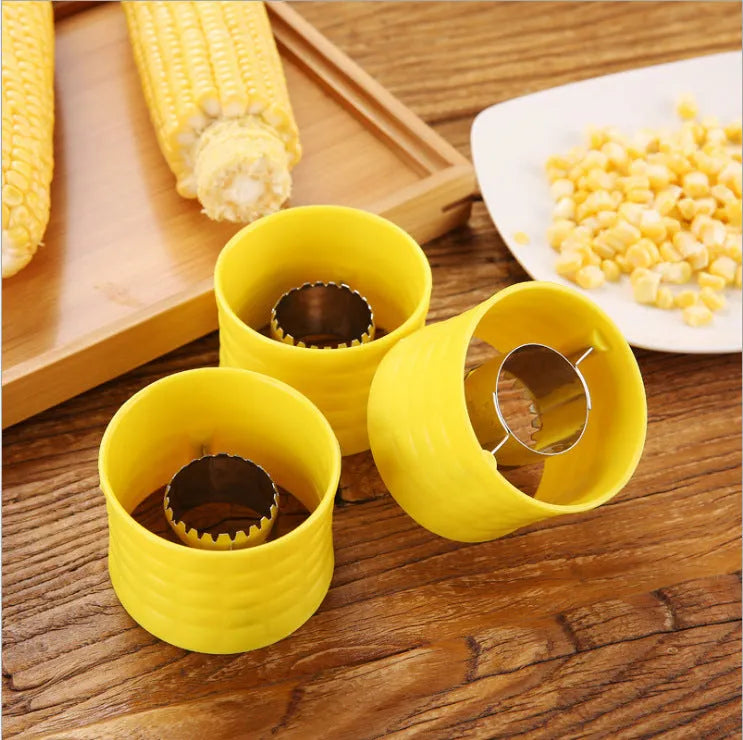 Yellow manual corn thresher kitchen tool with corn-shaped design for removing kernels.