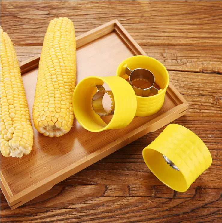 Yellow manual corn thresher kitchen tool with corn-shaped design for removing kernels.