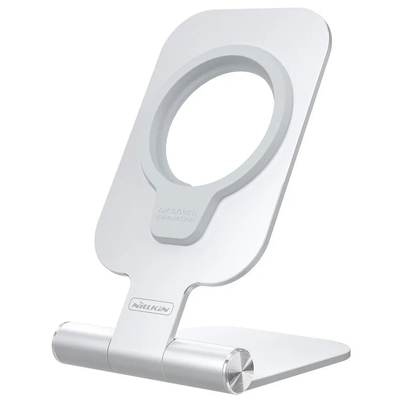 NILLKIN silver foldable aluminium alloy magnetic wireless charging stand for iPhone 12 Mini and 12 Pro Max on a desk