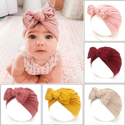 Soft acrylic knitted bonnet for a baby girl, shown in a solid colour, suitable for 0-28 month olds.