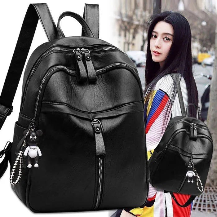 Soft black pu leather backpack with double shoulder straps and a luggage strap attachment