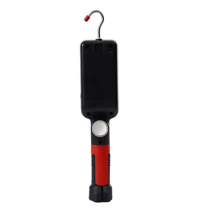 Red portable COB LED flashlight with a magnetic hook on a metal surface.